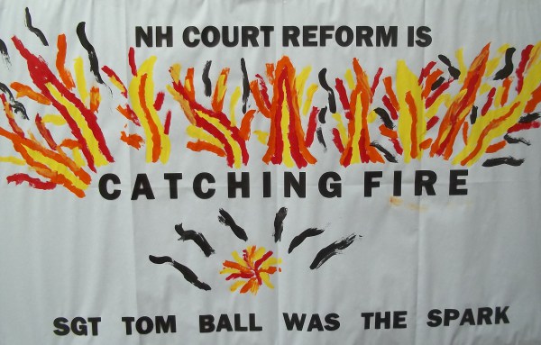 Poster at a memorial for Tom Ball, an MRA who advocated burning down courthouses and police stations.